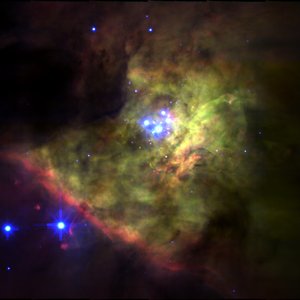 The Orion Nebula showing green/red ionized gas and blue stars